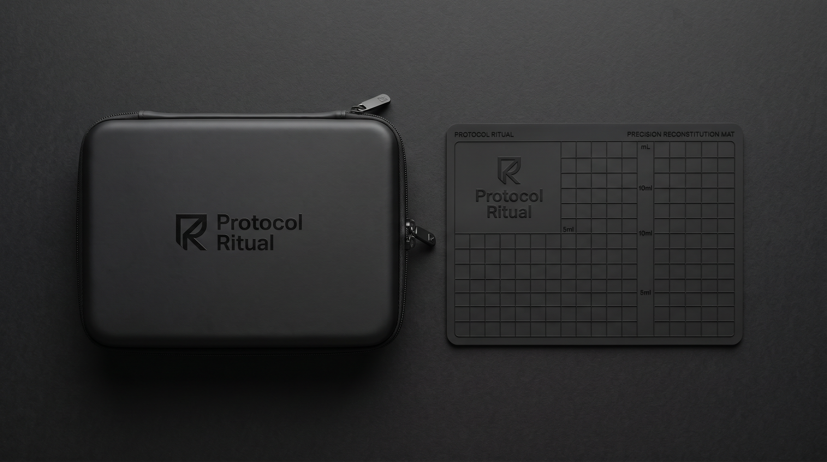 Protocol Ritual Home Kit black hardshell EVA case, closed, with embossed wordmark — TRT and peptide supply organizer.  Foldable silicone work surface mat from the Protocol Ritual Home Kit, unfolded